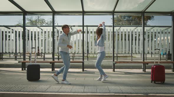 A Man and a Woman are Dancing Emotionally at a Bus Stop