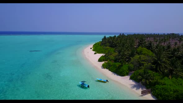 Aerial scenery of tranquil coast beach lifestyle by blue lagoon and white sandy background of a picn