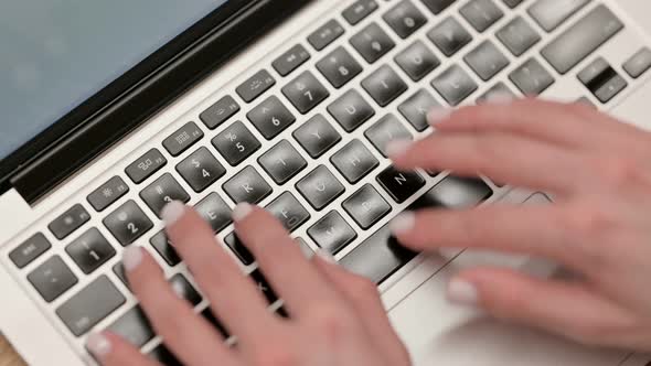 Top View of Female Hands Typing on Laptop Close Up