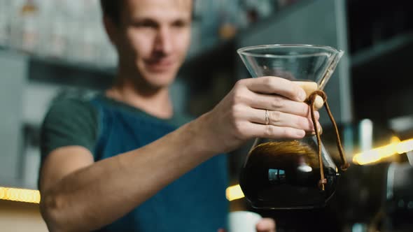 Process of making espresso in a coffee machine. Barista making latte in  specialty coffee shop.