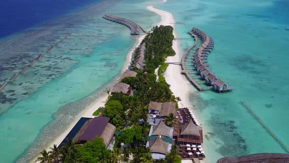 Aerial drone panorama of tropical shore beach by blue ocean with sand background