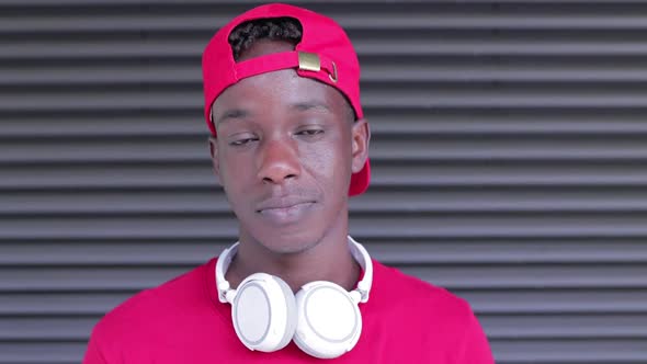 Portrait of Smiling Young African American Man with Headphones Smiling at Camera