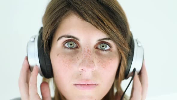 Teenage girl wearing headphones and listening to music