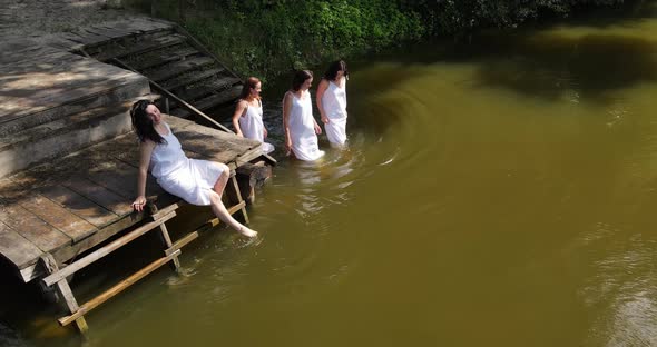 Girls In White Dresses Enter The River