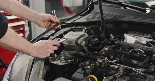 Car Mechanic Checking Antifreeze In The Car. Antifreeze Test