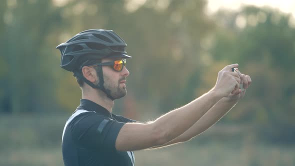 Cyclist Taking Selfie On Mobile Phone. Man Takes Picture On Phone After Cycling. Selfie Cyclist.