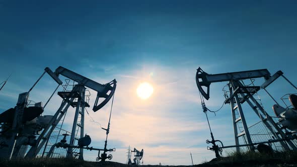 Sunlit Landscape with Two Derricks Pumping Petrol. Energy, Oil, Gas, Fuel Pumping Rig