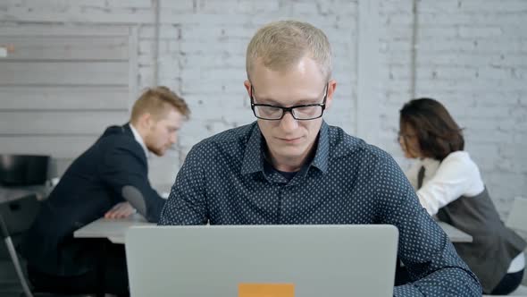 Man Using Laptop and Working in His Office