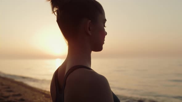 Closeup Fit Girl Meditating in Front Sunset Sky