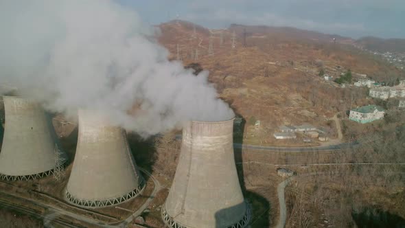 Aerial Orbital View of an Industrial Zone Pipes Pouring Thick White Smoke