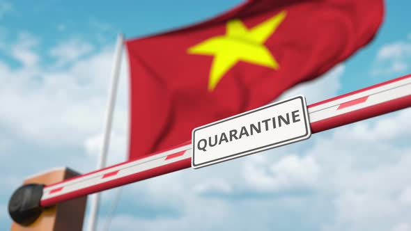 Opening Barrier with QUARANTINE Sign Against the Flag of Vietnam