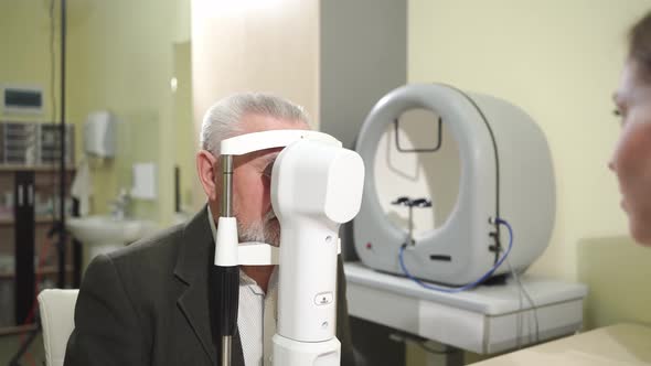 Ophthalmologist Examination of Elderly Man on Corneo Topographer