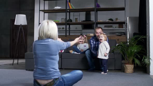 Back View of Mom Calling for Kid Learning To Walk