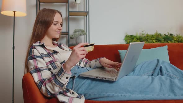 Woman Sitting at Home Using Credit Bank Card and Laptop Pc While Transferring Money Online Shopping