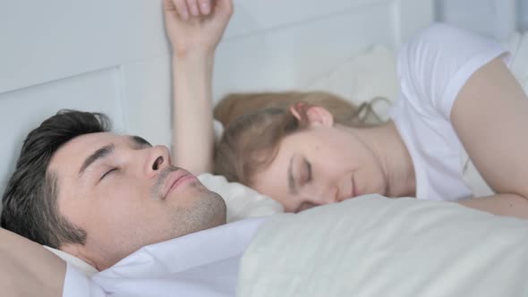 Couple Sleeping in Bed