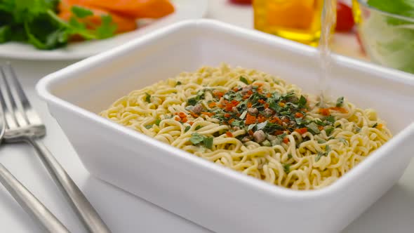 Water pouring into instant noodles, quick chicken soup