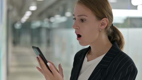 Young Businesswoman Having Loss on Smartphone