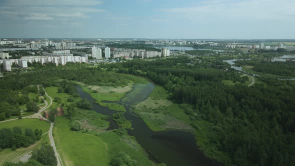 Flight Over The City Park. The River Is Visible. Aerial Photography From Above.