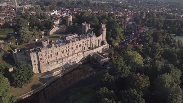 Orbital aerial shot over Warwick Castleing from left to right