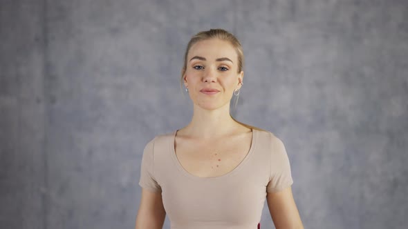 Portrait of an Attractive Female Coach Yoga Make Namaste Gesture By Hands