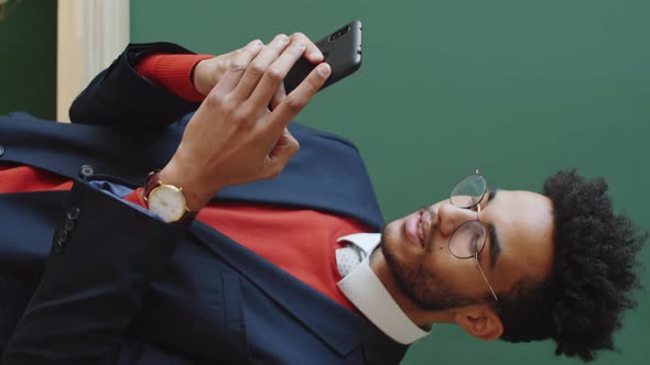 Young Businessman Texting on Smartphone