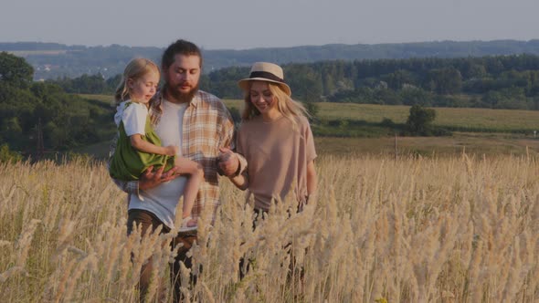Caucasian Happy Family Farmers Parents with Daughter Little Child Baby Kid Girl Walking on Wheat