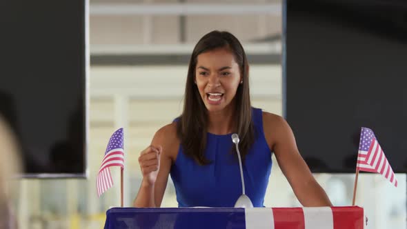 Female speaker addressing the audience at a political rally