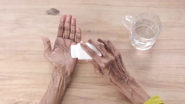 Senior Hand Holding Pills with Copy Space