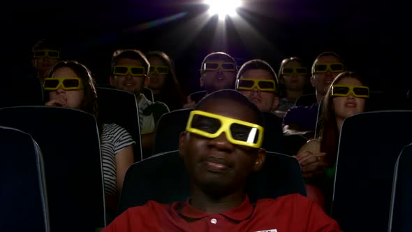 Happy Multiethnic Young Men Watching a 3-D Movie in the Theatre