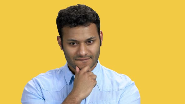 Close Up Man with Thoughtful Expression on Color Background