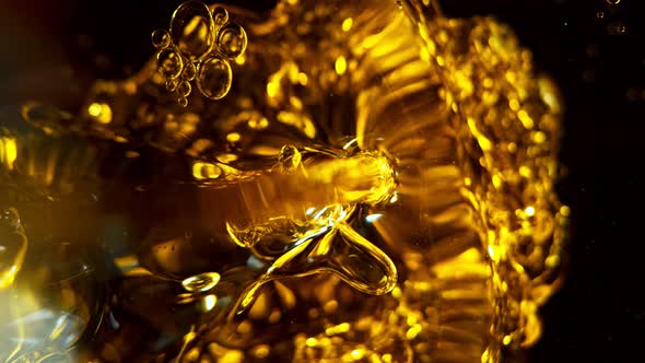 Super Slow Motion Shot of Pouring Oil Isolated on Black Background at 1000Fps