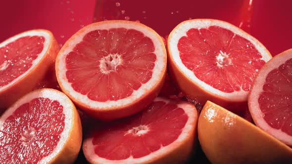 Slow Motion Shot of Grapefruit Juice Splashing Through Grapefruit Slices