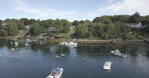 Flying over a harbor with sailboats and ships in Rockport, Maine.