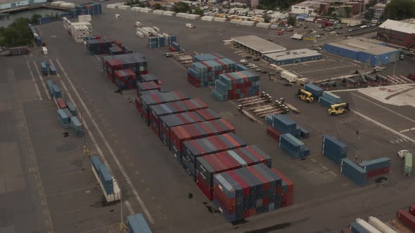 Flying Over Red and Blue Industrial Cargo Containers in Docks with New York City with