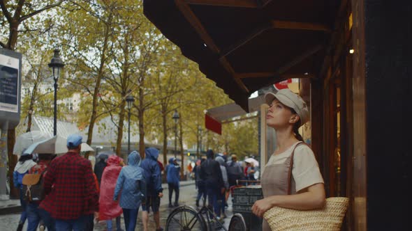 An attractive young girl looking rain