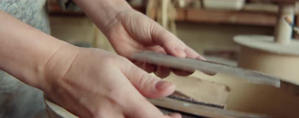 Hands of Potter Choosing Wooden Rib