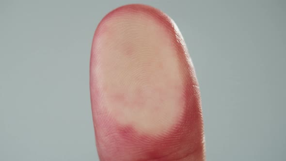 Human Hand Making Fingerprint on Grey Background