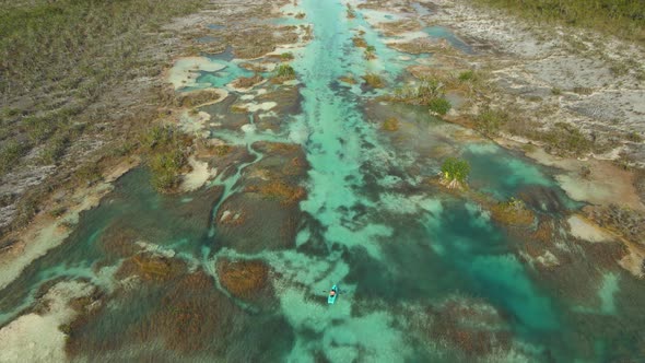 People Riding Kayak in Los Rapidos Lagoon in Bacalar Mexico