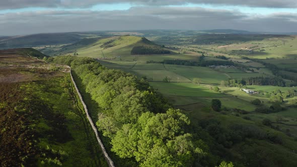 Beautiful low level aerial of the north york moors in early summer, showing a wooded area overlookin