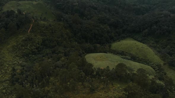 Above mountain valley aerial landscape with mountains peaks and clouds