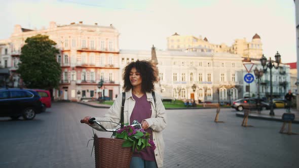 Ethnic Black Female in Casual Outfit and Backpack