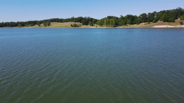 Close still with drone near the water level of a lake.