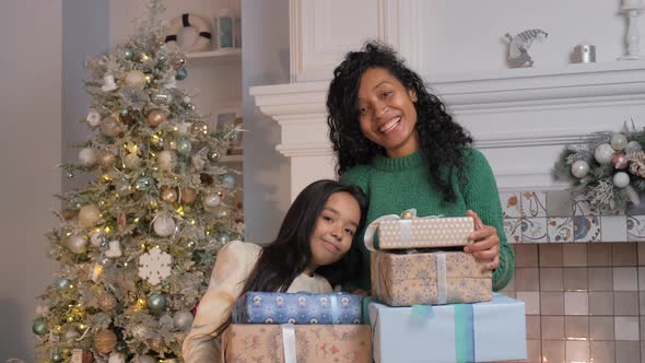 Woman and Brunette Daughter Smile Holding Gift Boxes