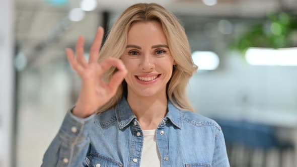 Appreciative Young Casual Woman with OK Sign By Hand 