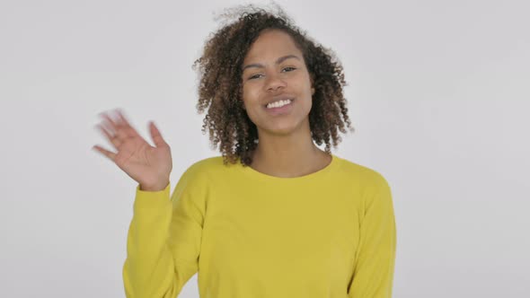 Young African Woman Waving Welcoming on White Background