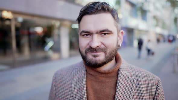 Portrait of Stylish Kind Man with Beard Standing on City Street and Showing No Head Sign Negation