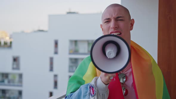 Queer Gay Person Screaming in Ager and Fighting for Their Rights with Rainbow Flag on Shoulders