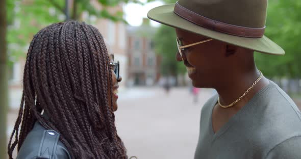 Close Up of African Young Man and Woman Holding Hands and Talking Outdoors