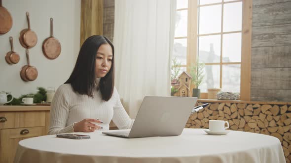 Young Adult Businesswoman Discussing Her Report on a Video Conference Call From Her Apartment