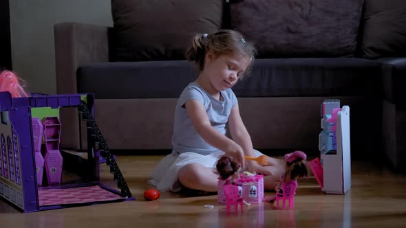 Little Six Years Girl Playing in Her Room with a Dolls